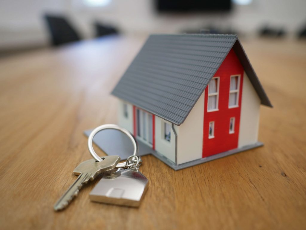 A miniature house and keys